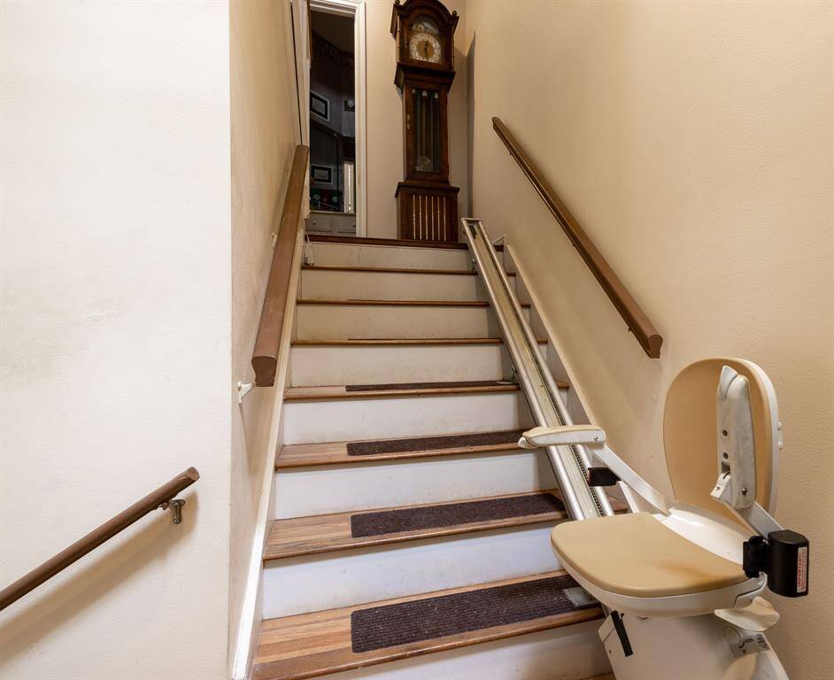 Looking inside from the front door entry with stairs leading to the second floor and to the left is the staircase to the first floor bedroom and garage.