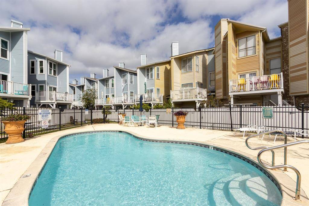 Large pool with ample patio fully fenced. Subject condominium is the one on the right behind the terracotta urn.