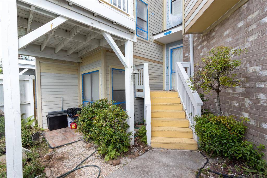 Yellow steps to front door. Upper left is the balcony off the living room.