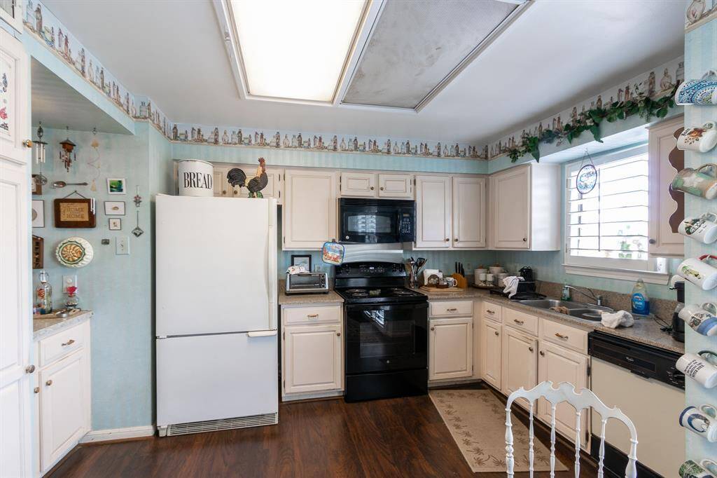 Kitchen.  Please note on the Seller Disclosure that the Seller has never used the dishwasher or the disposal. Window on the right overlooks the back driveway along the north side of the complex.