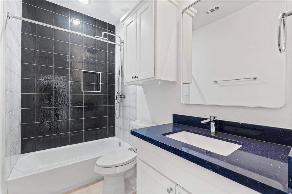 Conveniently located upstairs, the laundry room features washer and dryer connections and shelving for extra storage.