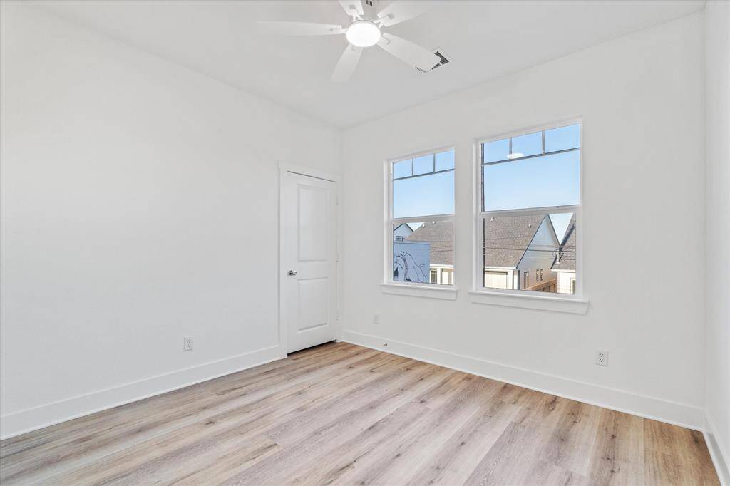 This cozy second bedroom offers a ceiling fan for comfort, two windows that brighten the space, and a roomy walk-in closet to keep everything organized.