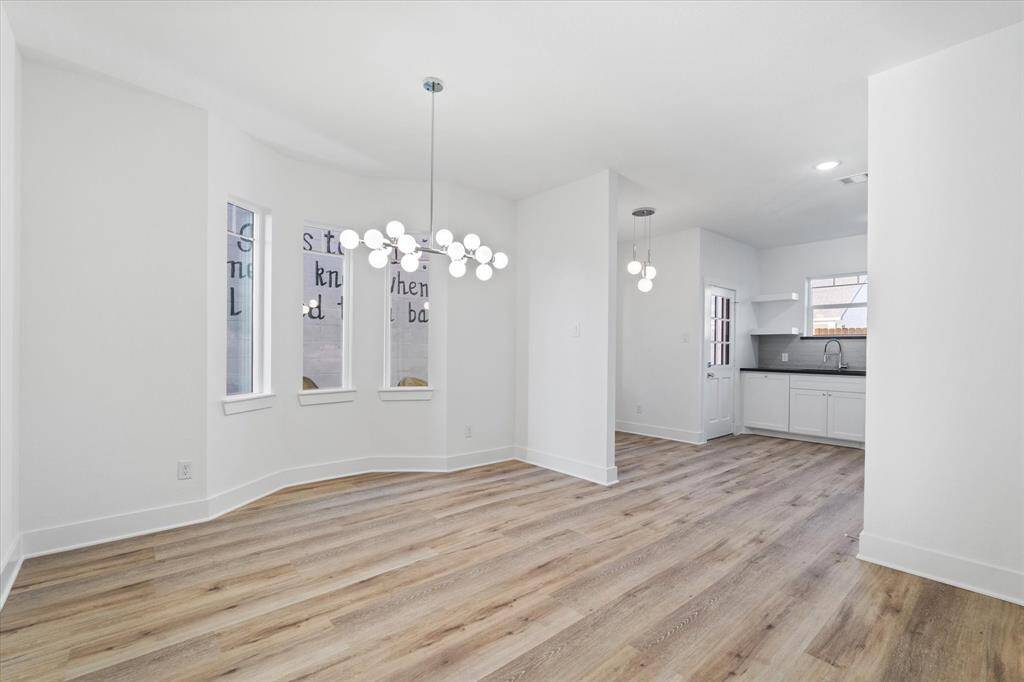 Come on in and make yourself at home! The large living room offers luxury vinyl floors, a white ceiling fan paired with recessed lighting, and charming bay windows that let in tons of natural light.
