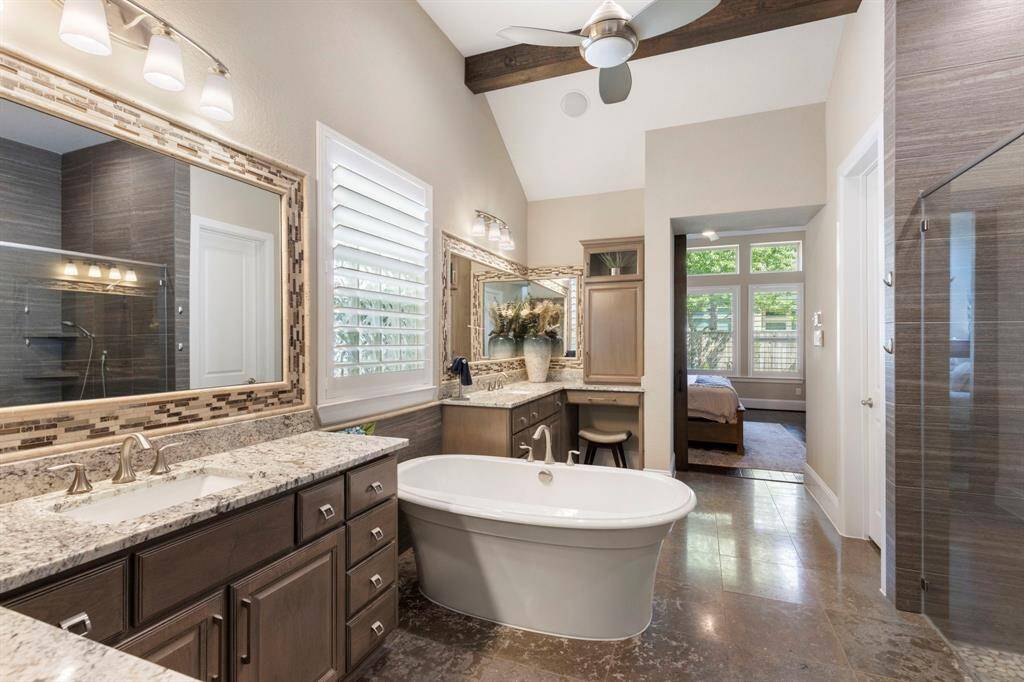 Spacious primary bath with his and her vanity areas.
