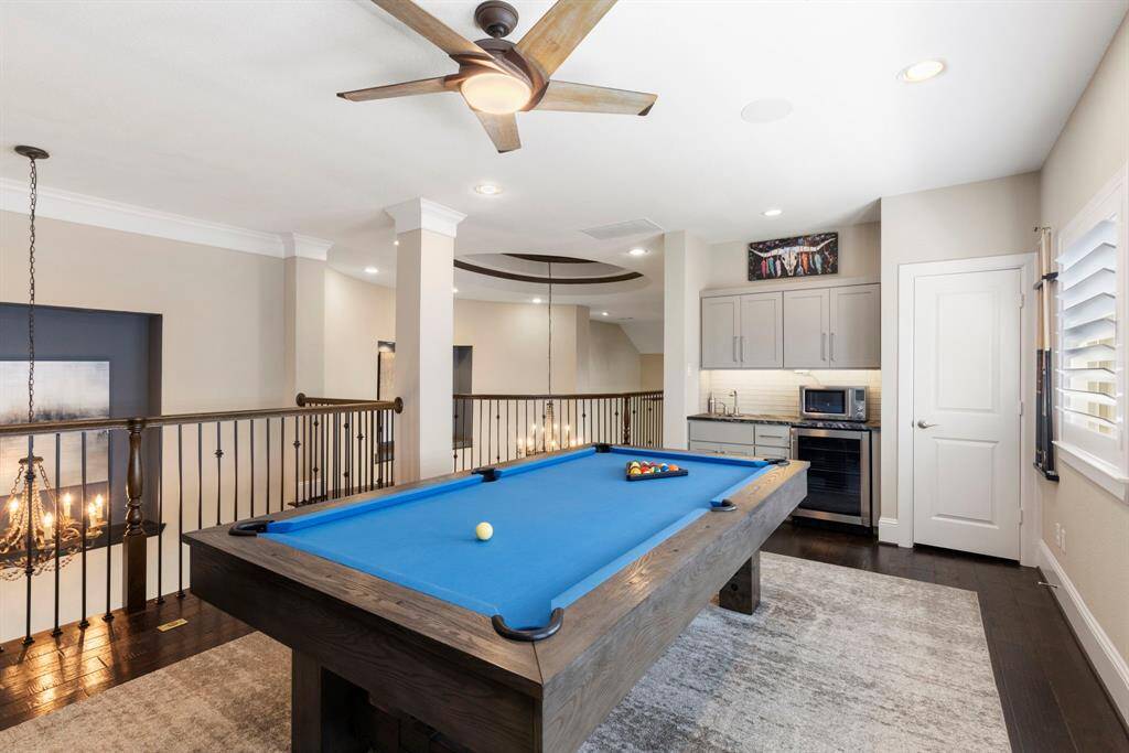 Gameroom upstairs with a wet bar and a wine fridge.