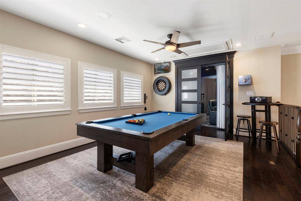 Gameroom cusrrentlu has a pool table, electronic dart board, game closet and wet bar.