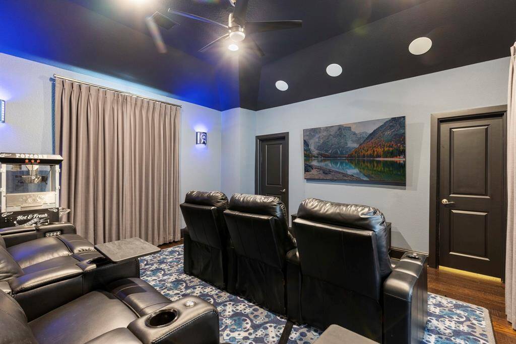 Theater seats, sconces and electric lutron curtains.