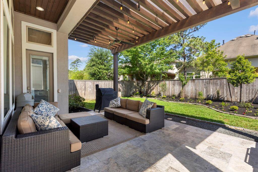Extended covered pato, with pergola and outdoor kitchen.