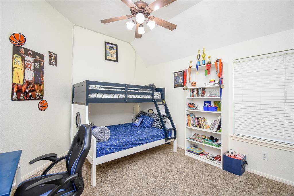 This is a bright, cozy bedroom with a large window providing natural light.
