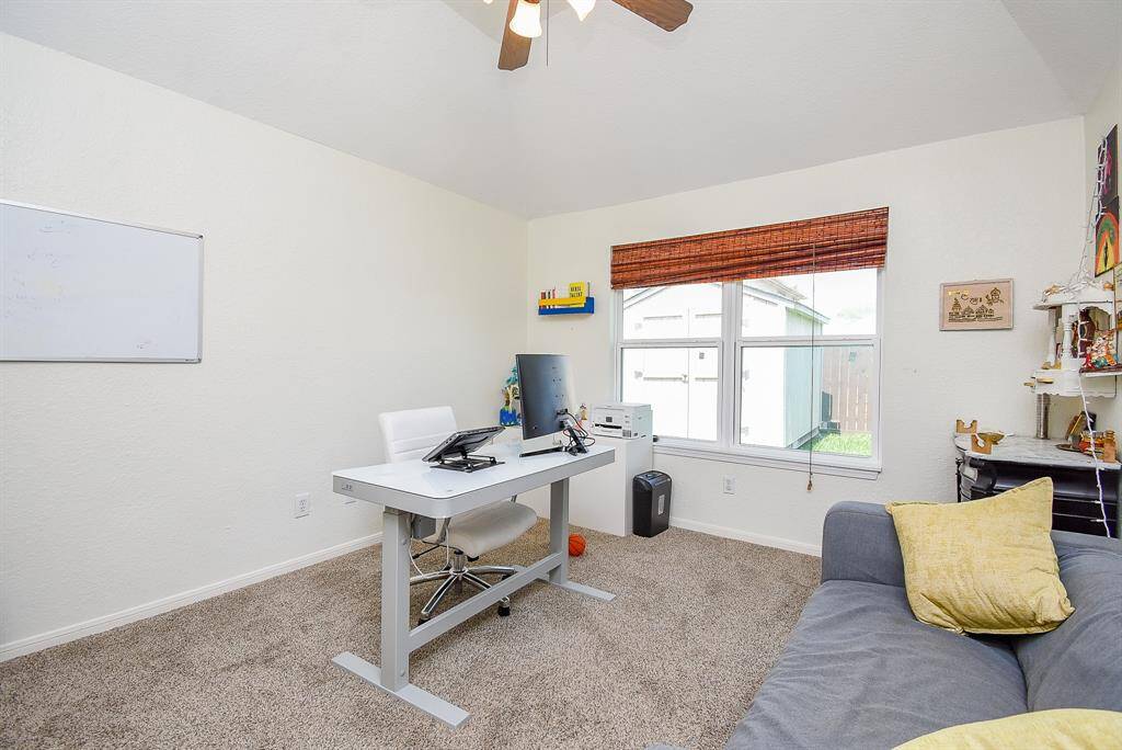Another spacious bedroom being used as an office space.