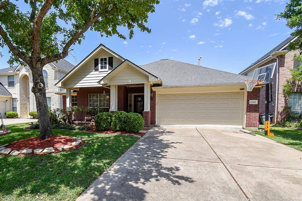 The brick exterior adds to its classic appeal, while the driveway offers ample parking space.