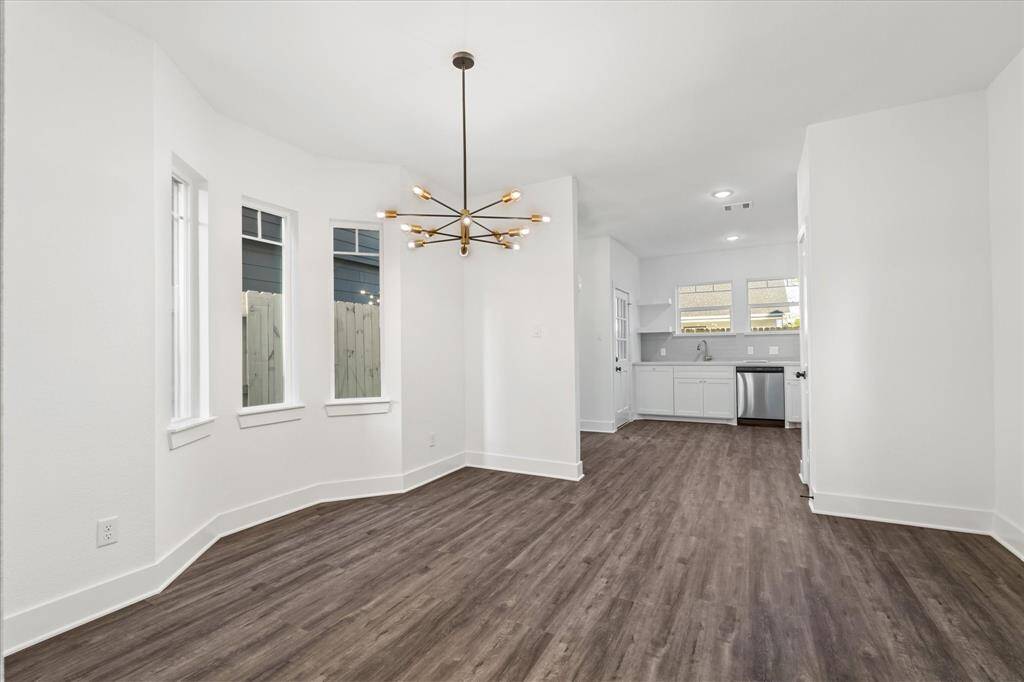 The half bathroom on the first floor includes a black quartz countertop, black & gold fixtures, and built-in shelving above the toilet for décor or linens.