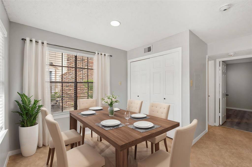 Dedicated Dining Room offers direct access to the Gourmet Kitchen, terrific tile flooring, and oversized windows which fills the space with natural lighting. (Virtually Staged)