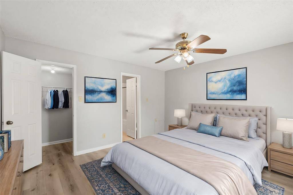 An additional view of the Prestigious Primary Suite which boasts upgraded flooring, spacious walk-in closet and convenient access to the Primary Bath Oasis. (Virtually Staged)