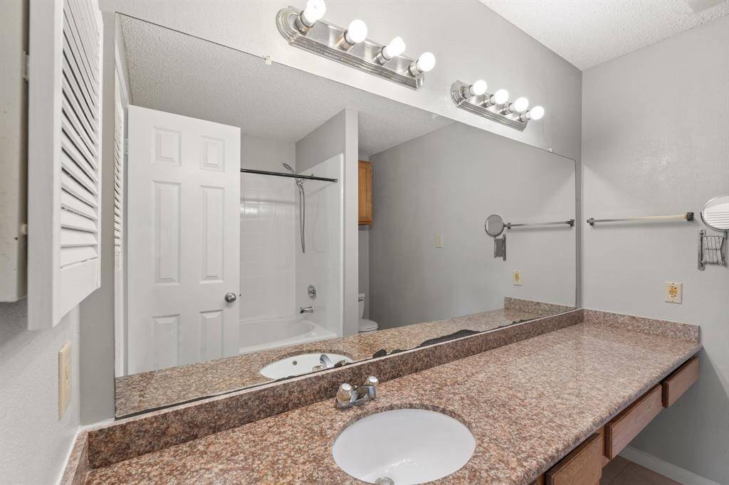 The Primary Bath Oasis features an extended countertop with sitting area, tub/shower combo with tile surround and built-in storage for added convenience.