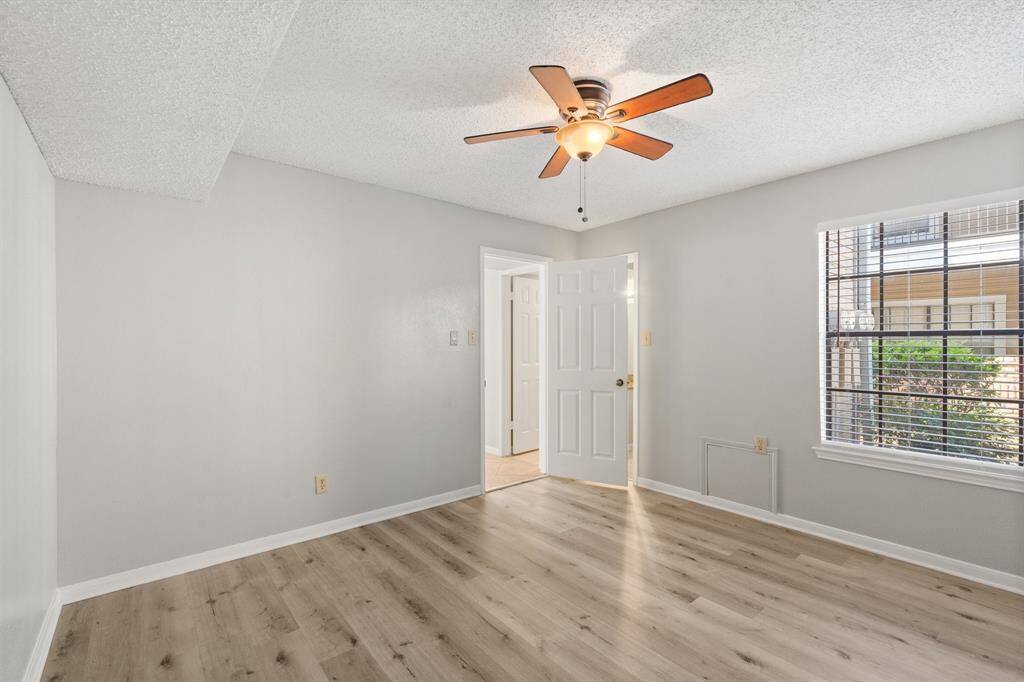 Striking Secondary bedroom featuring upgraded flooring, neutral finishes and easy access to the private bathroom.