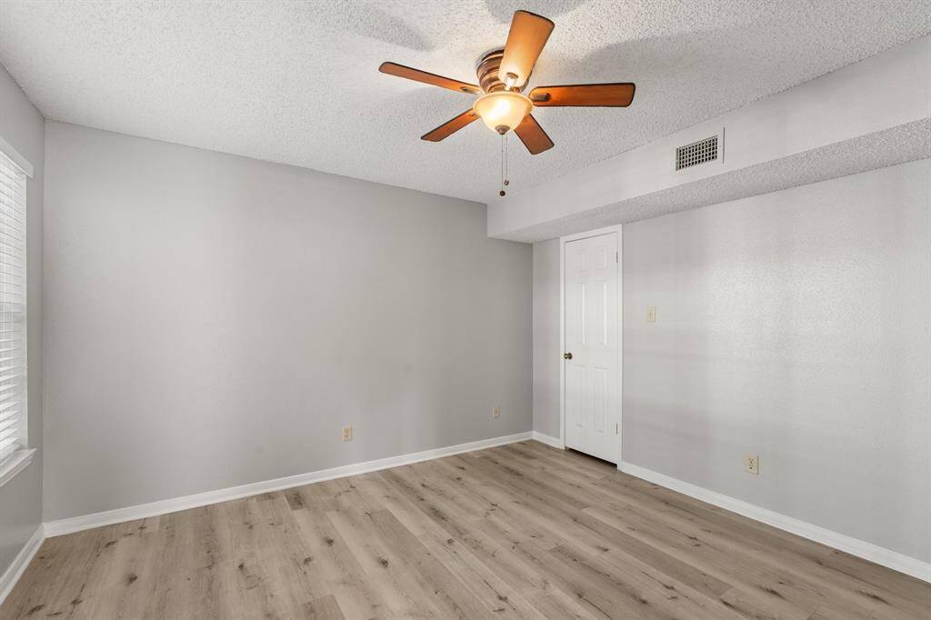 Another view of the Striking Secondary bedroom featuring upgraded flooring, neutral finishes and spacious walk-in closet.