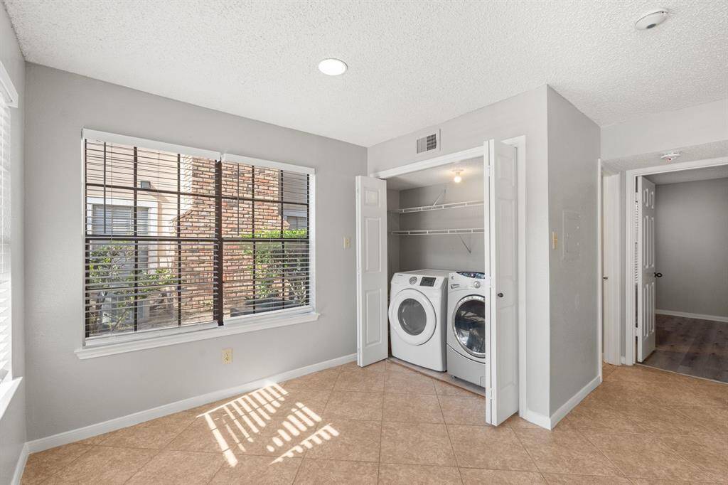 Convenient In-House Utility Room featuring storage shelving to ensure your laundry day is a breeze!