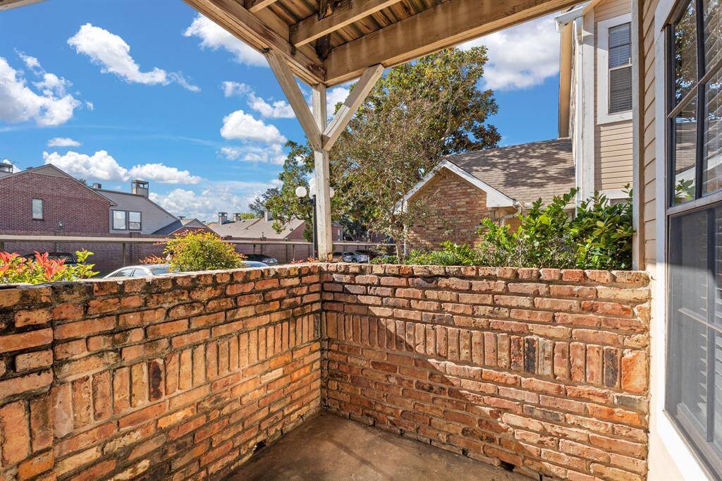 Private covered patio offers sitting area and views of the serene Riverwalk Condo community!
