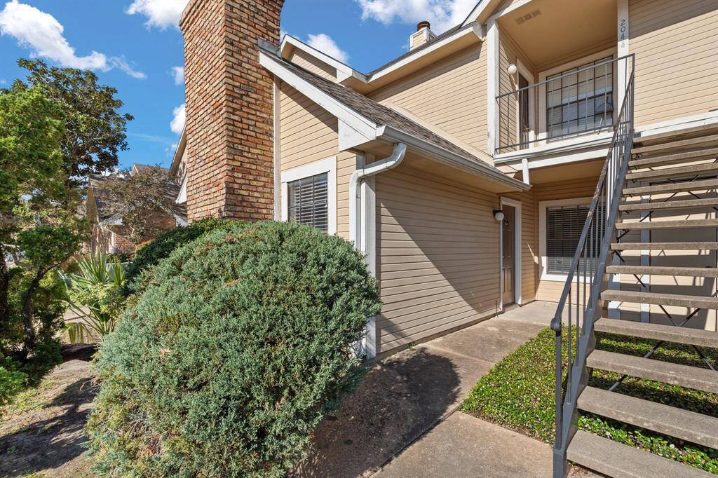 An additional view of the private entry way and luscious landscaping surrounding the home!