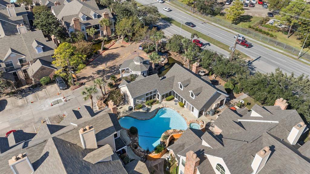 An additional aerial view showcasing one of many community pools, 24 hour manned gate and Riverwalk Condo community center.