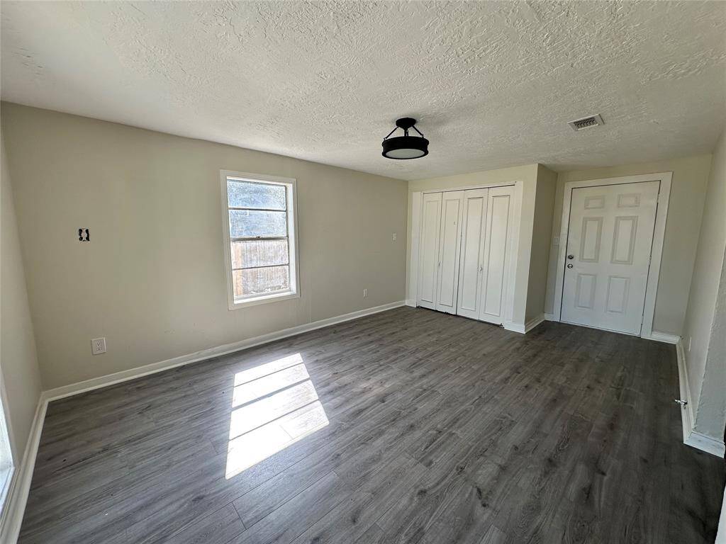 Spacious living room with direct backyard access.