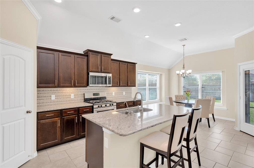 Kitchen with expansive island with additional seating.