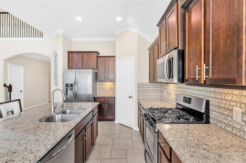 Granite countertops, custom tile backsplash and stainless-steel appliances.