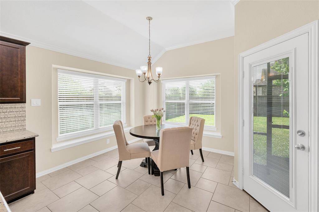 Dining room with dual windows overlooking the backyard.