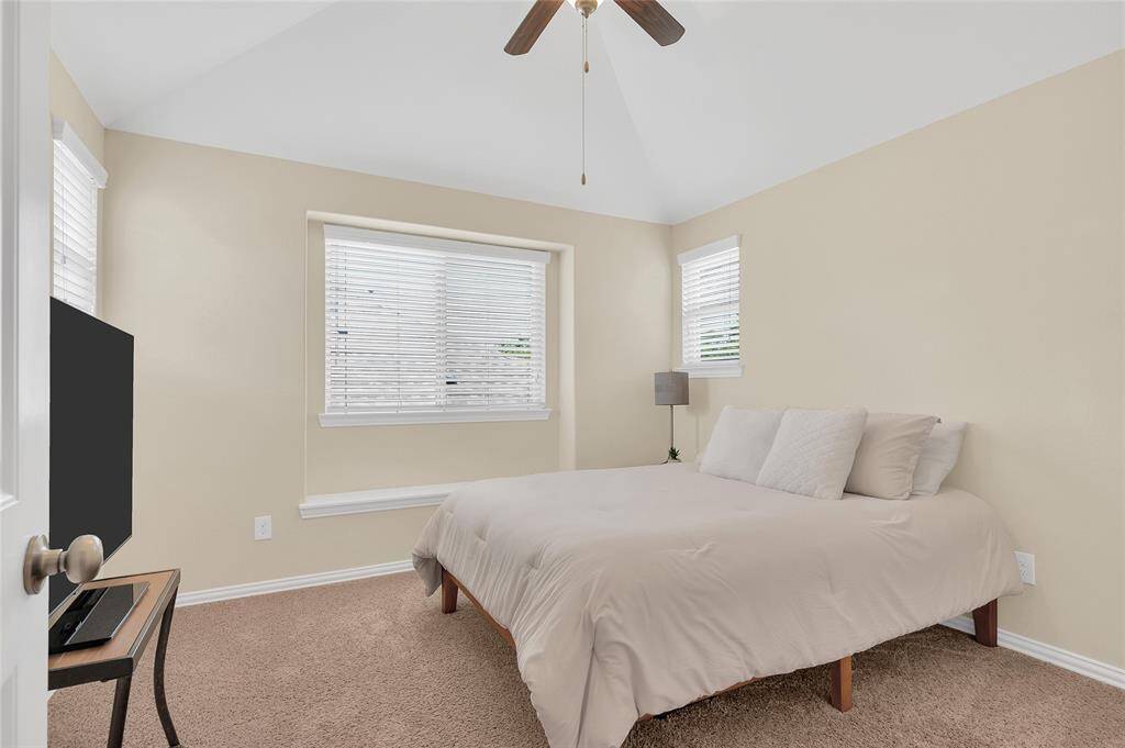 4th bedroom suite upstairs features vaulted ceilings and ample lighting.