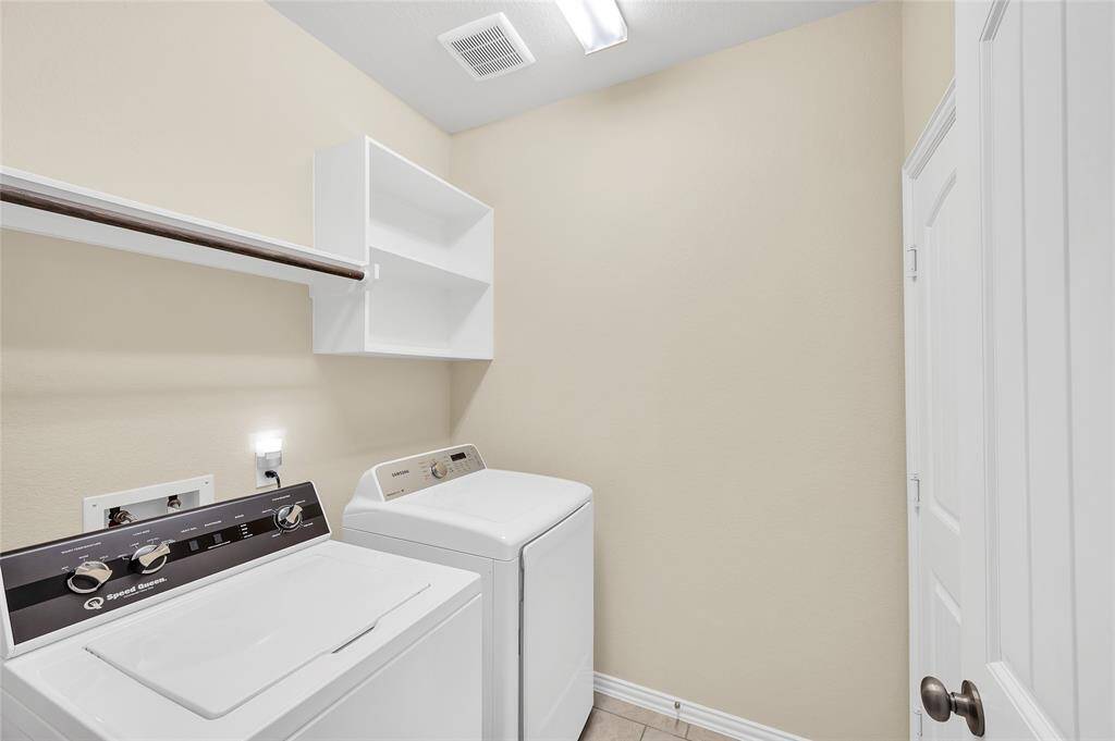 Laundry room with built-ins. Washer and dryer will stay with the home.