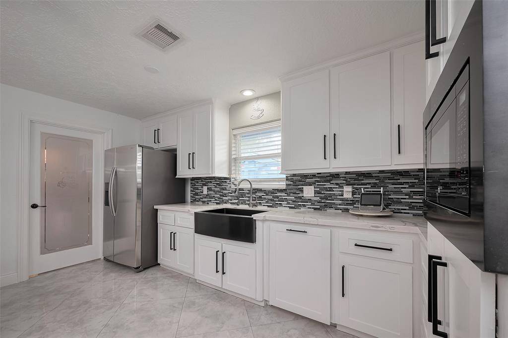 Utility room and pantry are located next to the refrigerator
