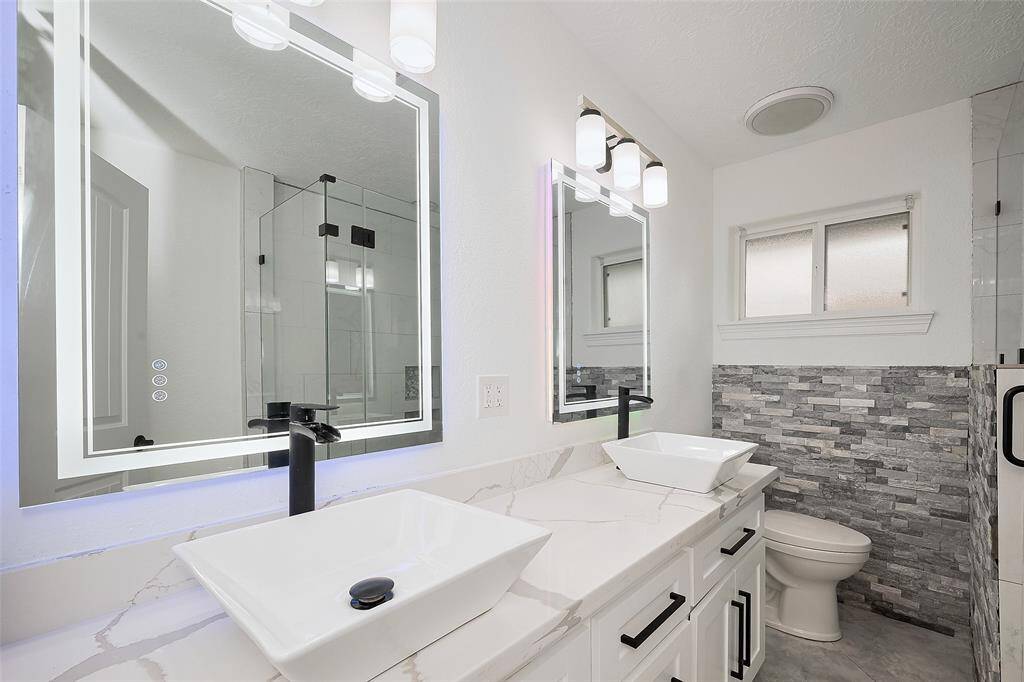 Full bath next to the spare bedrooms with double since and state-of-the-art mirrors