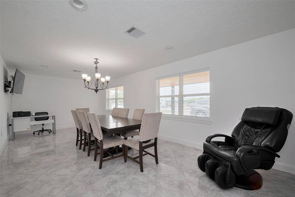 Extra large dining room with plentiful natural light, new recessed lights, AND new windows.