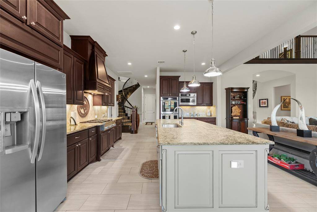 Granite countertops paired with a coordinating stone backsplash not only provide a durable and elegant surface for food preparation but also add a touch of luxury and sophistication to the kitchen.