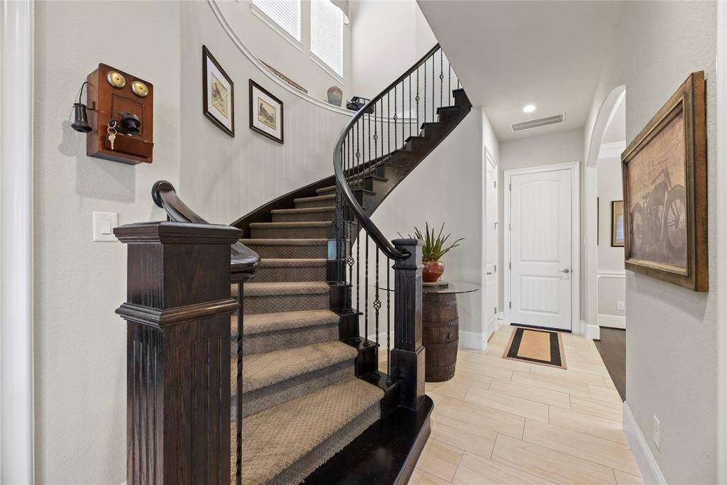 The second staircase, seamlessly connecting to the game room, offers unparalleled convenience and accessibility.