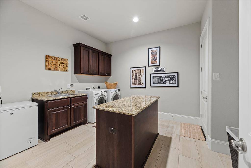 This well-appointed space includes ample storage and efficient organization, making laundry day a breeze while keeping your home tidy and functional.