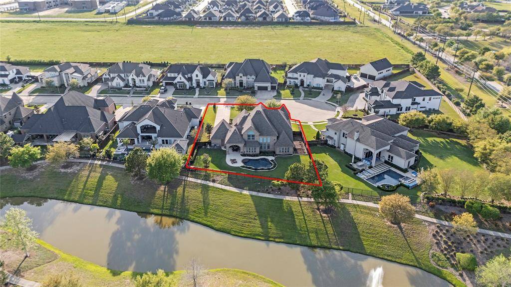 An aerial view showcases this expansive cul-de-sac lot, perfectly positioned for privacy and tranquility. The lush backyard surrounds a sparkling pool, creating an idyllic oasis. With ample space for outdoor living and recreation, this lot offers a rare combination of openness, seclusion, and luxury.