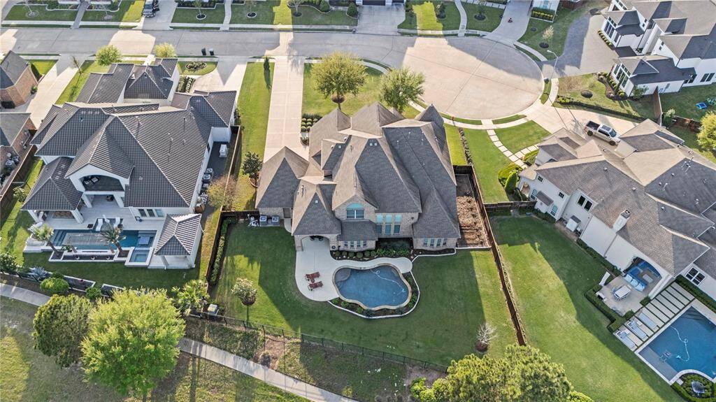 An aerial view showcases this expansive cul-de-sac lot, perfectly positioned for privacy and tranquility. The lush backyard surrounds a sparkling pool, creating an idyllic oasis. With ample space for outdoor living and recreation, this lot offers a rare combination of openness, seclusion, and luxury.