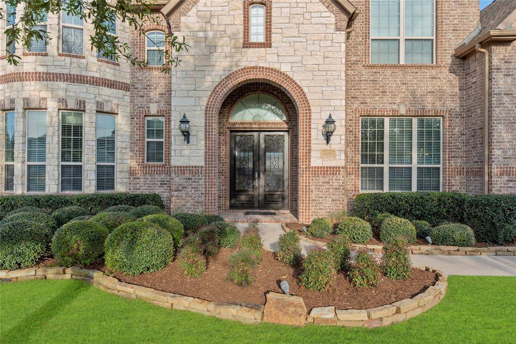 The stone and brick exterior exudes charm and elegance, creating exceptional street appeal that captivates at first glance.