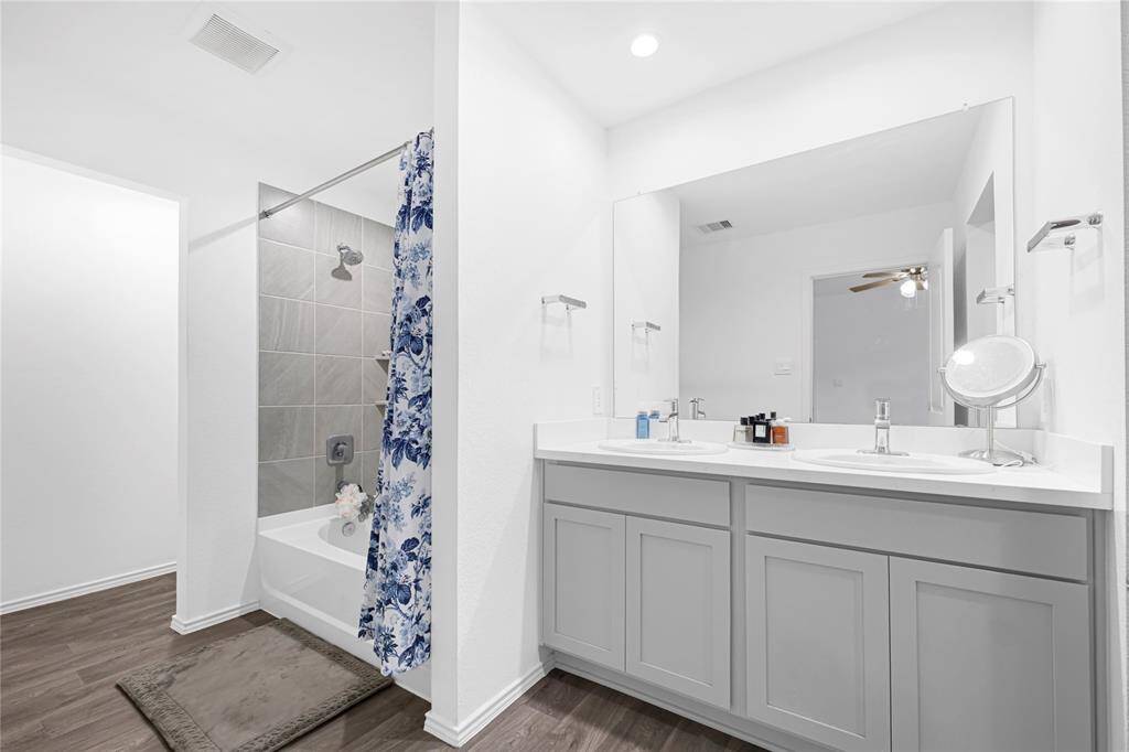 Primary bathroom with upgraded quartz countertops.