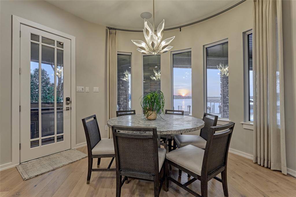 A wall of butte glass windows in the breakfast area provide views of amazing sunsets. Take note of the exquisite light fixture!