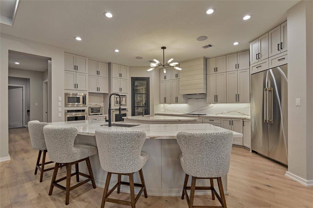 No detail was spared in this culinary oasis. From the modern countertops and backsplash to the chef-grade appliances, even the placement of lighting was thought out carefully.