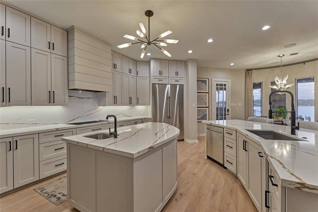 A center island for for food prepping houses a veggie sink and additional storage.