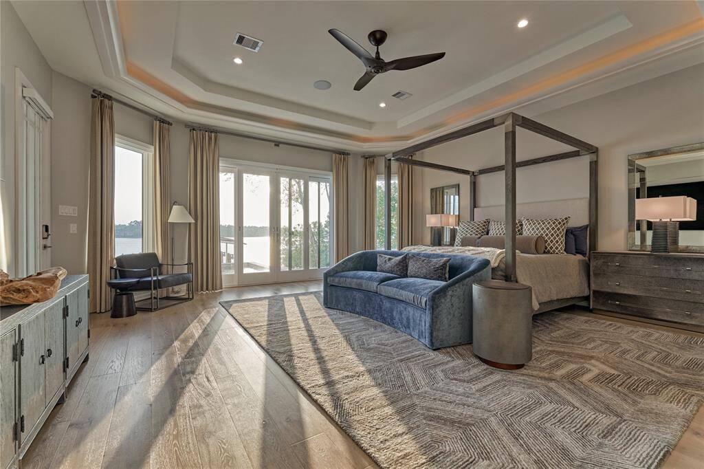 The primary retreat is a spacious peaceful sanctuary overlooking the beautiful Lake Conroe. It features His & Hers closets w/built-in's that include drawers, shelves and hanging space. There is also a wall mounted safe for important documents and valuables.