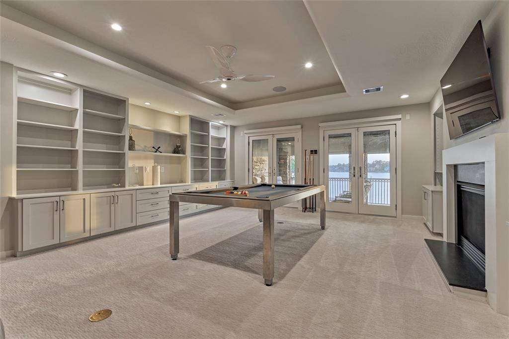 The game room features unbelievable storage options and has Double French Doors to the balcony.