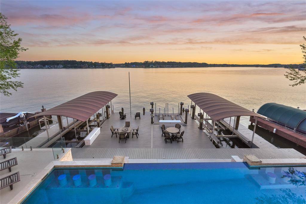 Updates on the boat dock include new galvanized sheet pile bulkhead, composite decking, 2 separate slips w/bikini tops independently powered cradle lifts, dual PWC lift, Swim Stairs and Dock Boxes.