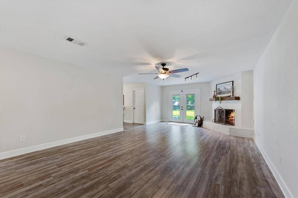 Conveniently located to the left of the living area are the kitchen, laundry, and dining spaces.