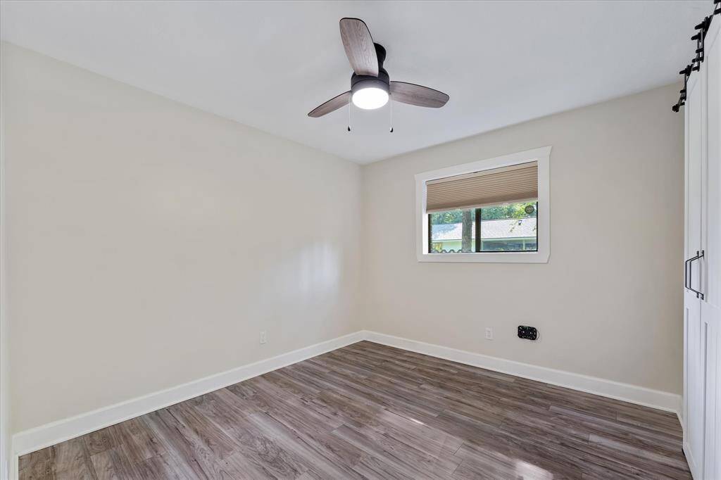 This secondary bedroom offers exceptional privacy, thanks to the adjacent double lot.