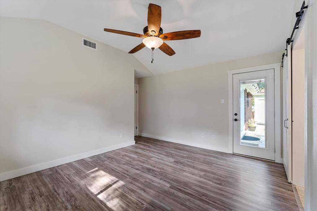 Spacious primary bedroom with direct access to a serene back patio.